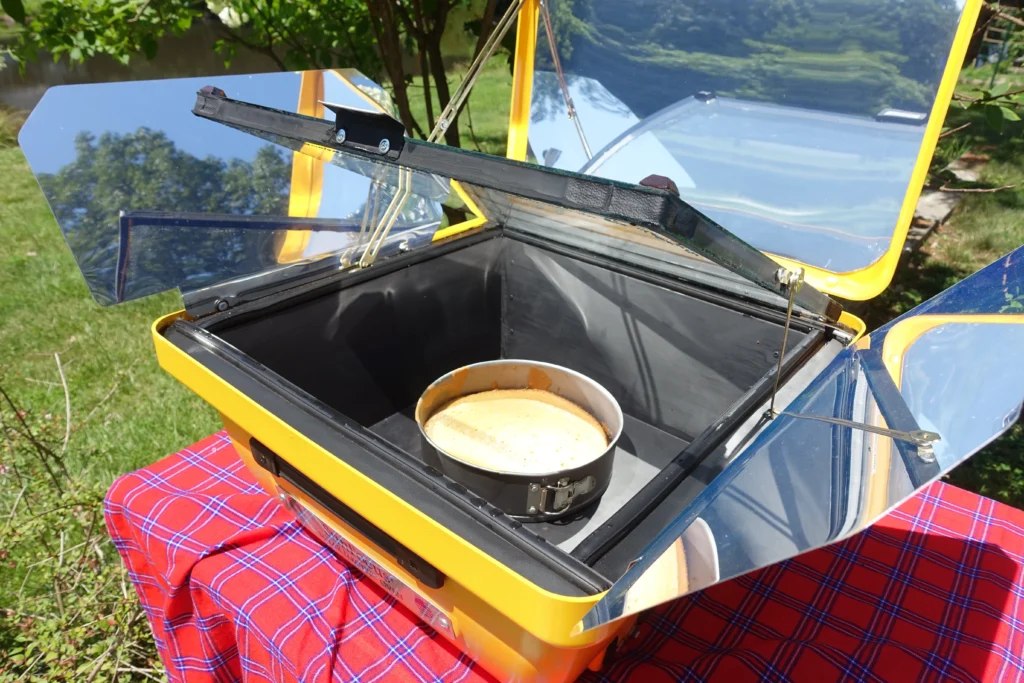 SunFocus solar oven baking food using renewable solar energy during a solar cooking demonstration