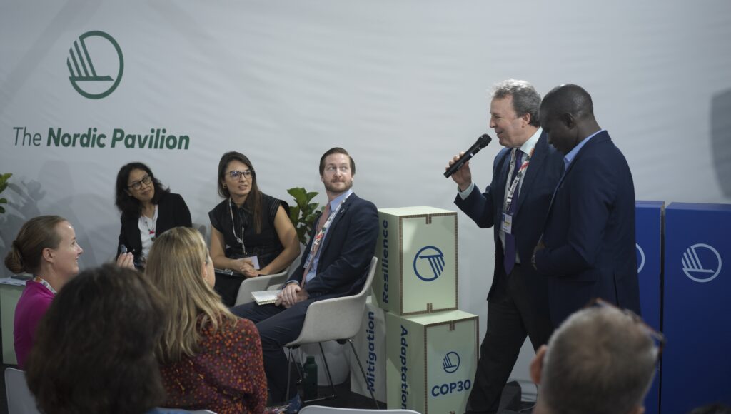 SCI representatives presenting solar cooking as a climate resilience solution at COP30
