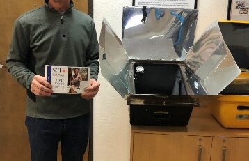 SCI volunteer presenting solar cooking at the "Our Planet Our Future" United Nations anniversary climate event