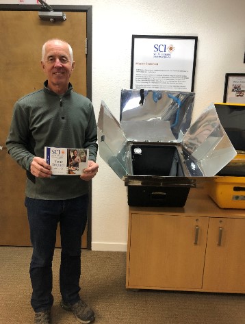SCI volunteer demonstrating a solar cooker during the United Nations anniversary event
