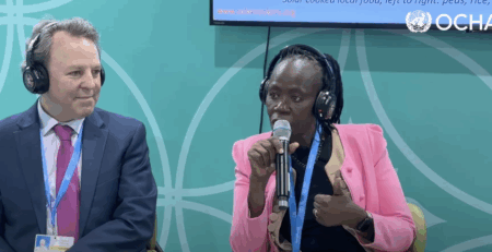 SCI representatives presenting solar cooking solutions for refugee families at the COP29 Humanitarian Hub