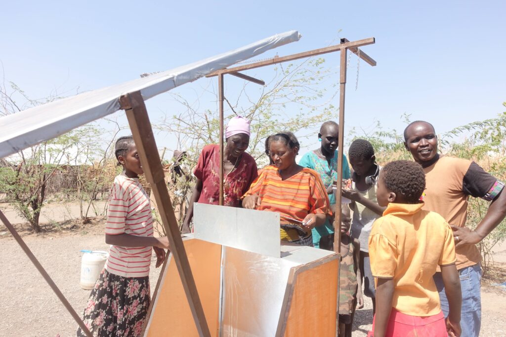 Families in Kakuma Refugee Camp using solar cookers to prepare meals with sunlight energy