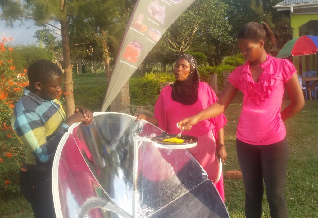 Solar cooking demonstration at a restaurant in Uganda preparing an omelet with a solar cooker