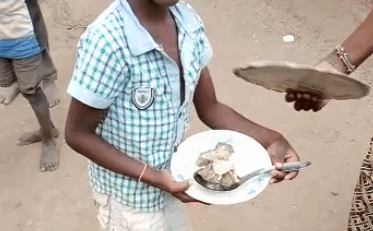 Ibrahim and his family enjoying a solar-cooked meal at Kakuma Refugee Camp, Kenya