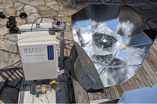SCI staff testing a solar cooker using specialized measuring equipment