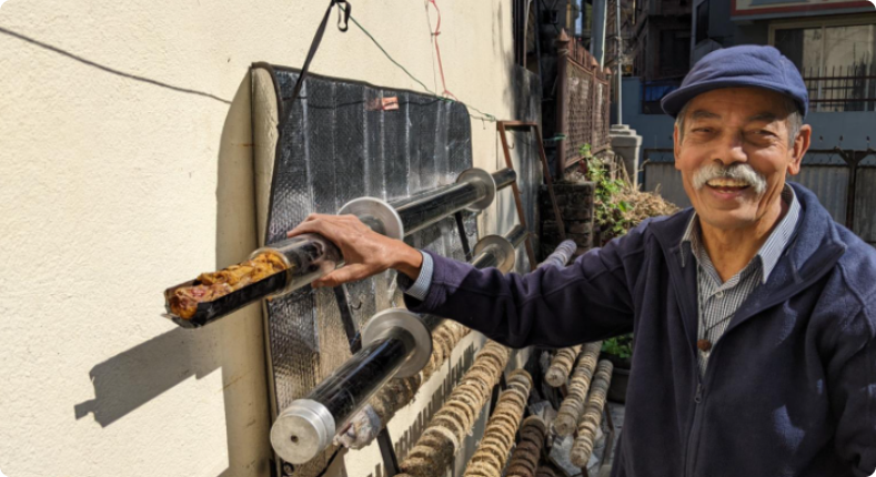 Family using a solar cooker in a mountainous region of Nepal