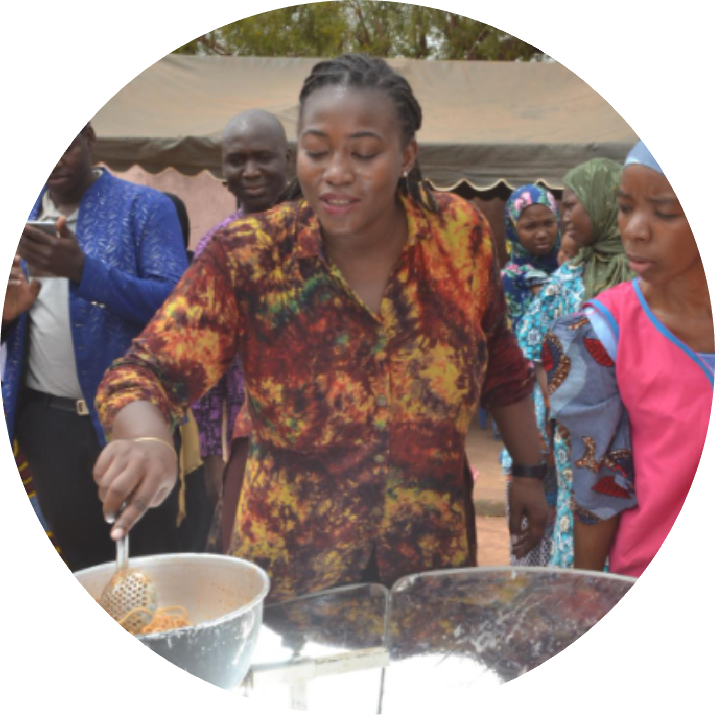 Community members using solar cookers to prepare meals together