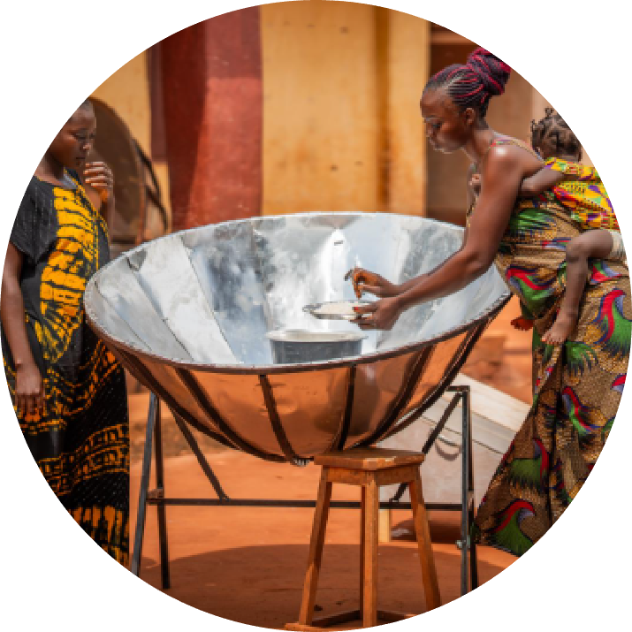 Program participants gathered with solar cookers after completing training
